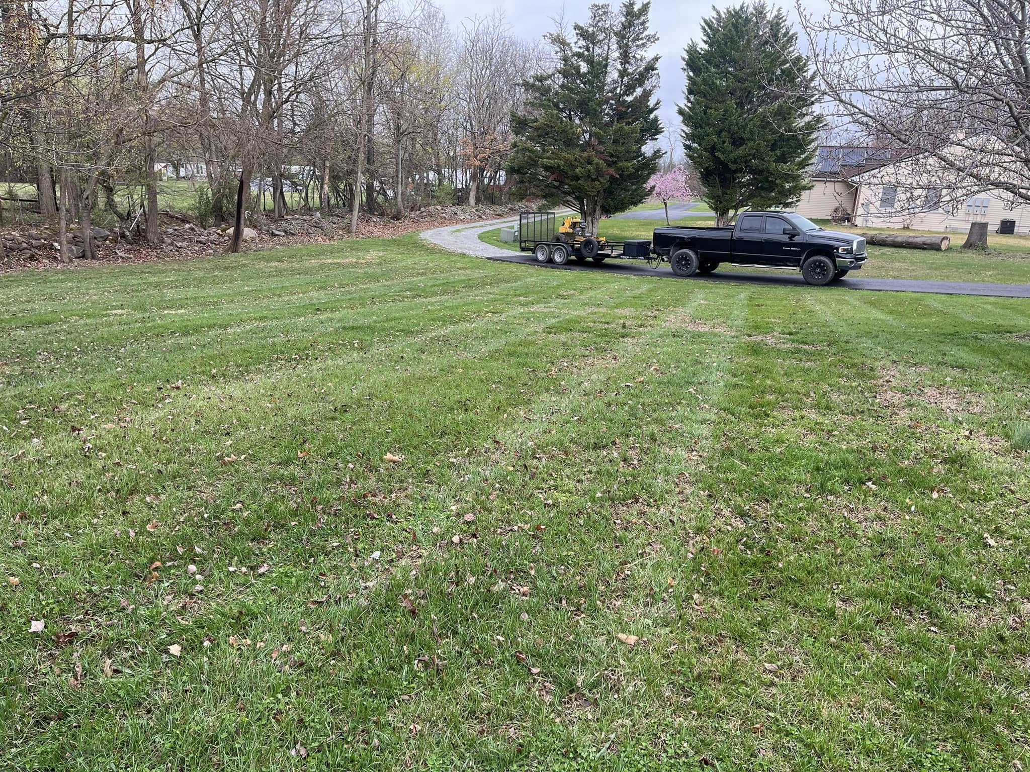 Strite's Lawn Care truck and equipment trailer on site