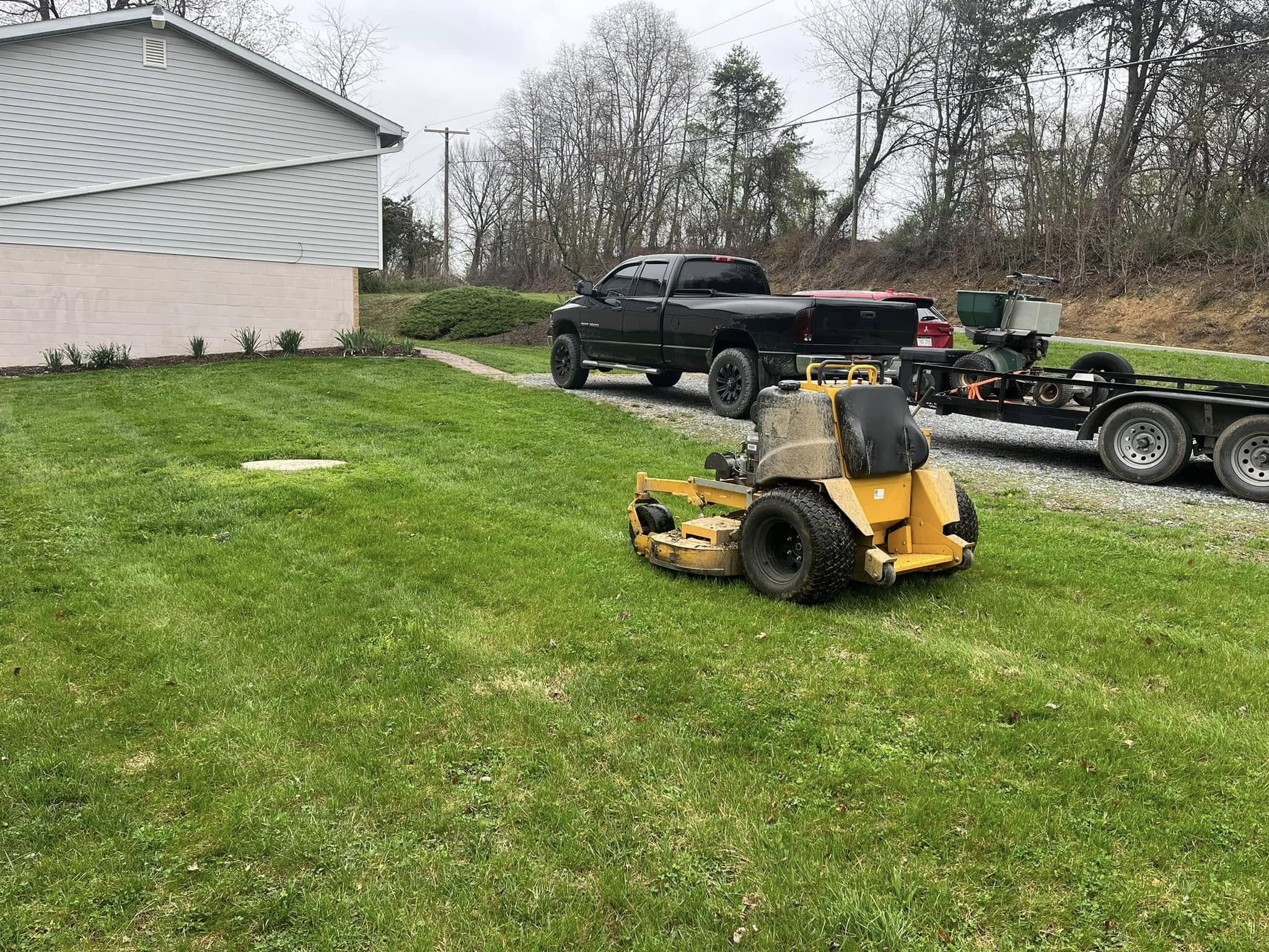 Commercial stand-on mower at a residential job site